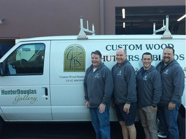 Four male employees standing in front of the Custom Wood Shutters and Blinds work van.