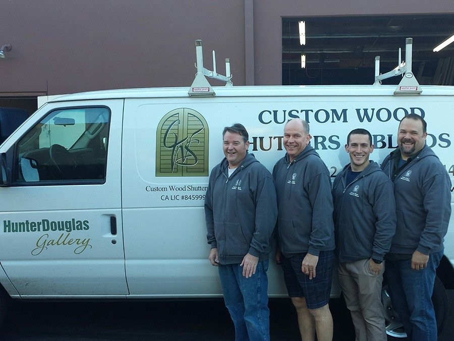 Four male employees standing in front of the Custom Wood Shutters and Blinds work van.